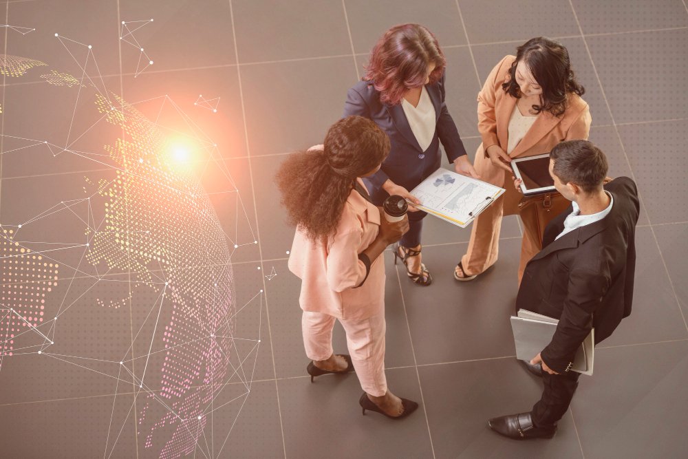 Business professionals discussing documents in an office with a glowing network graphic