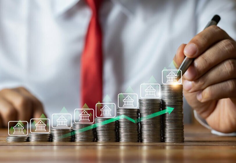Rising stacks of coins, representing salary budgeting and payroll services for businesses